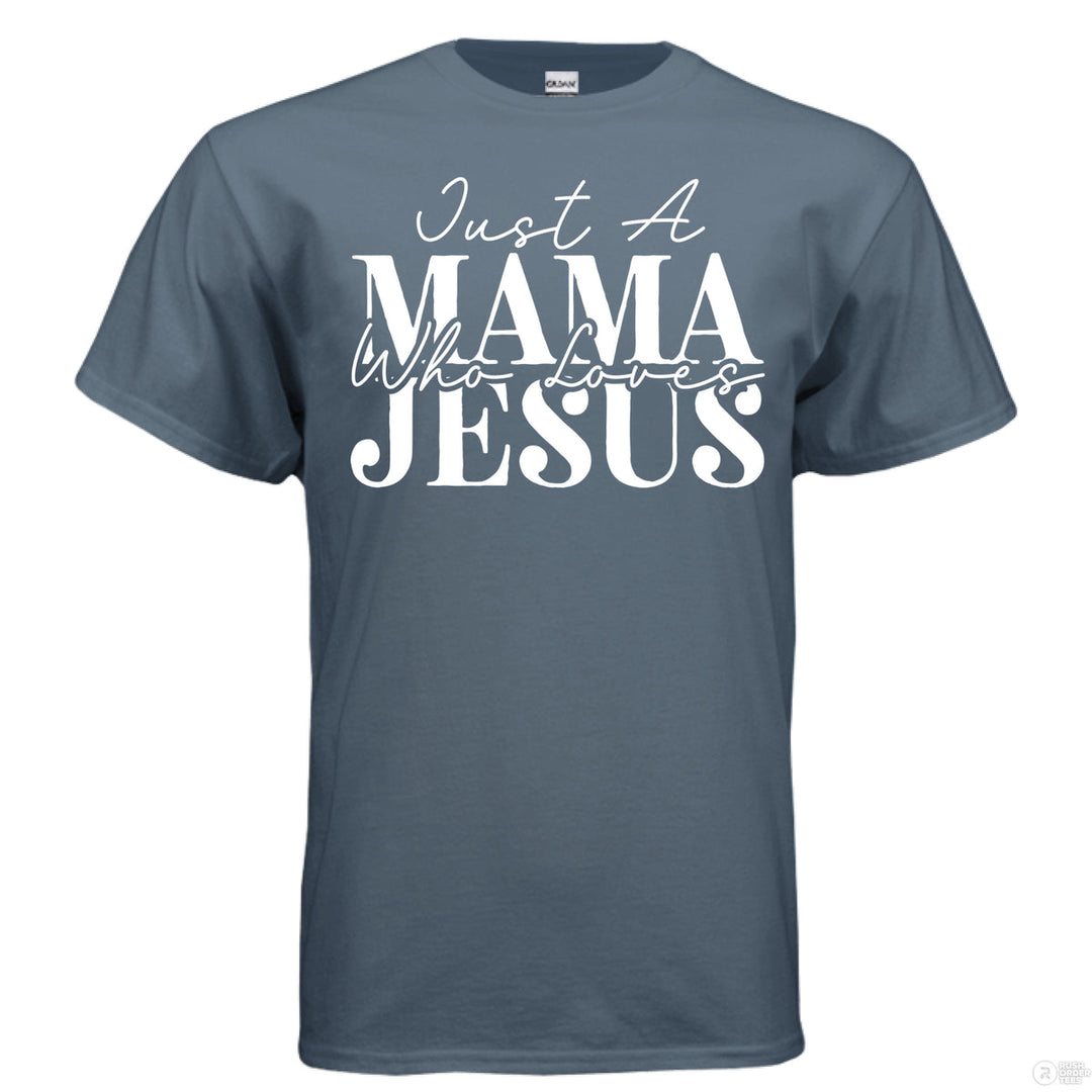 Indigo blue Christian t-shirt with bold white text reading ‘Just a Mama Who Loves Jesus’ in mixed script and block font
