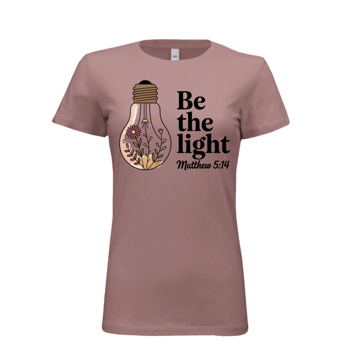 Women's fitted tee in mauve with a floral light bulb graphic and the words “Be the light – Matthew 5:14” in bold and script fonts.