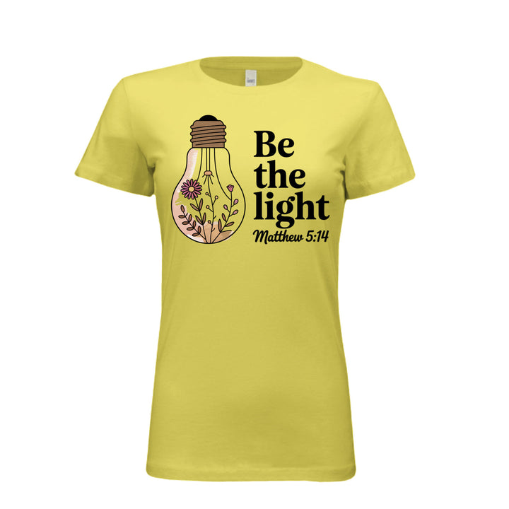 Women's fitted tee in yellow with a floral light bulb graphic and the words “Be the light – Matthew 5:14” in bold and script fonts.