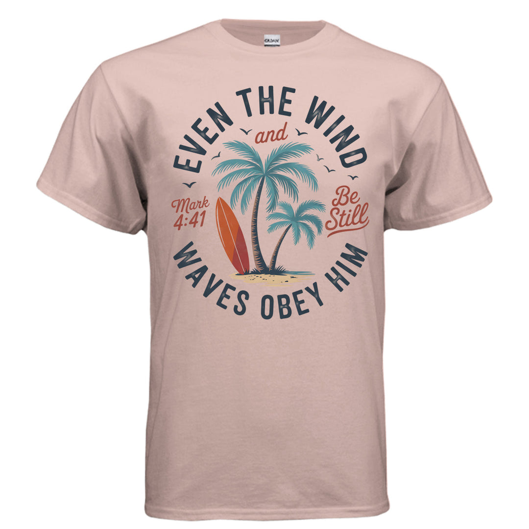 Dusty rose Christian t-shirt with palm trees, a red surfboard, and the words ‘Even the wind and waves obey Him – Mark 4:41’ and ‘Be Still’