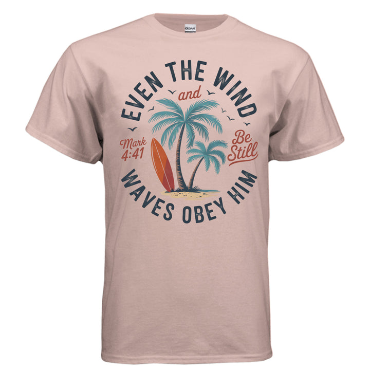 Dusty rose Christian t-shirt with palm trees, a red surfboard, and the words ‘Even the wind and waves obey Him – Mark 4:41’ and ‘Be Still’