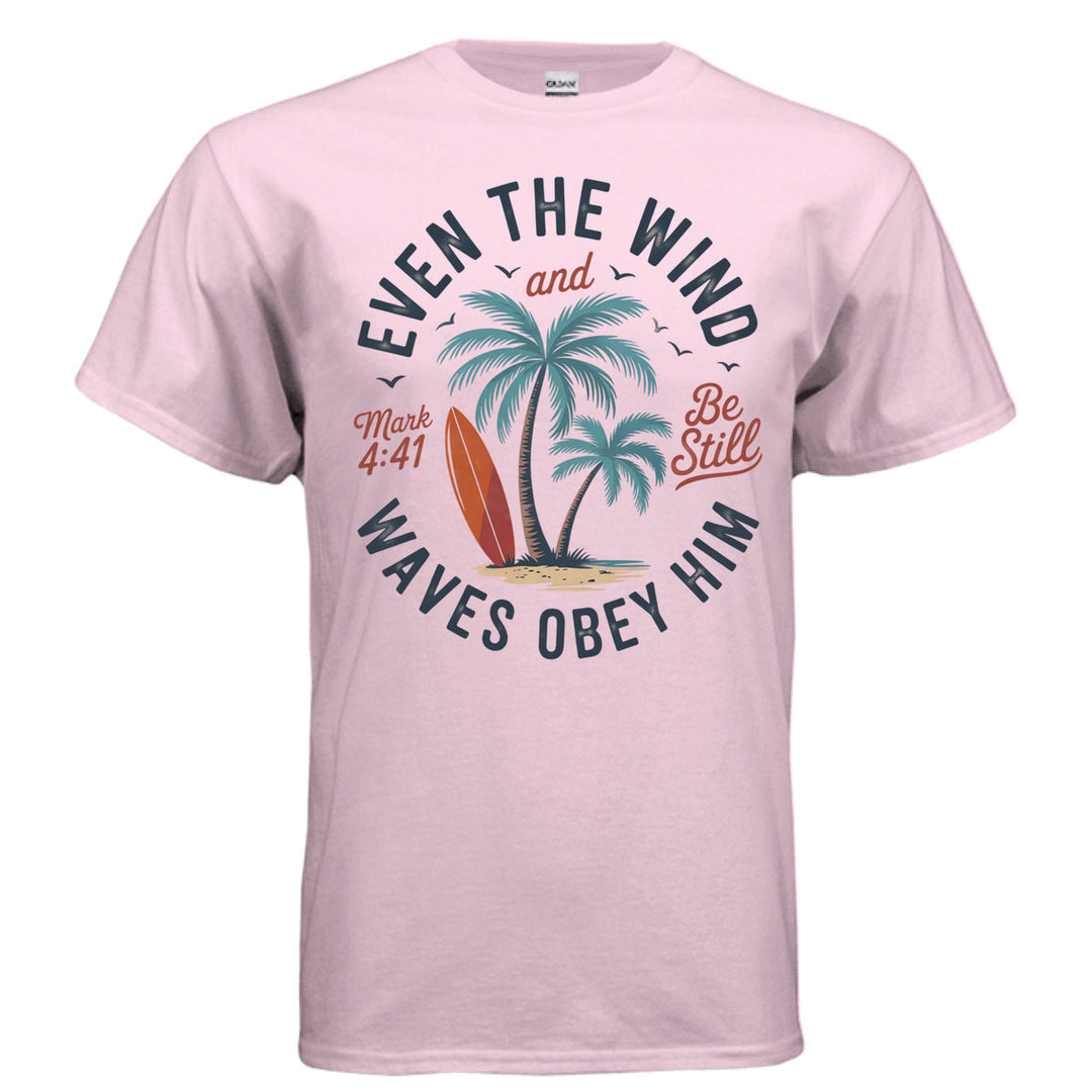 Light pink Christian t-shirt with palm trees, a red surfboard, and the words ‘Even the wind and waves obey Him – Mark 4:41’ and ‘Be Still’