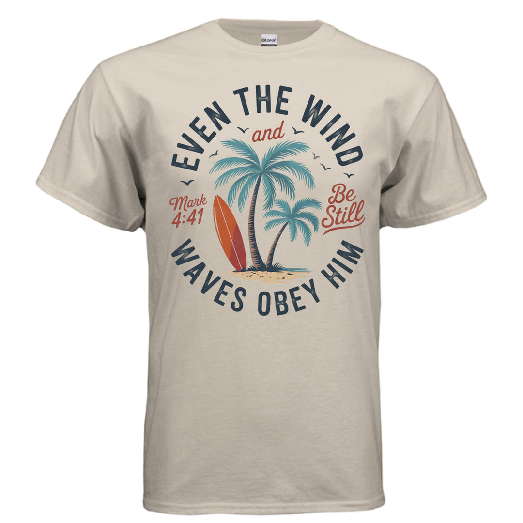 Sand Christian t-shirt with palm trees, a red surfboard, and the words ‘Even the wind and waves obey Him – Mark 4:41’ and ‘Be Still’