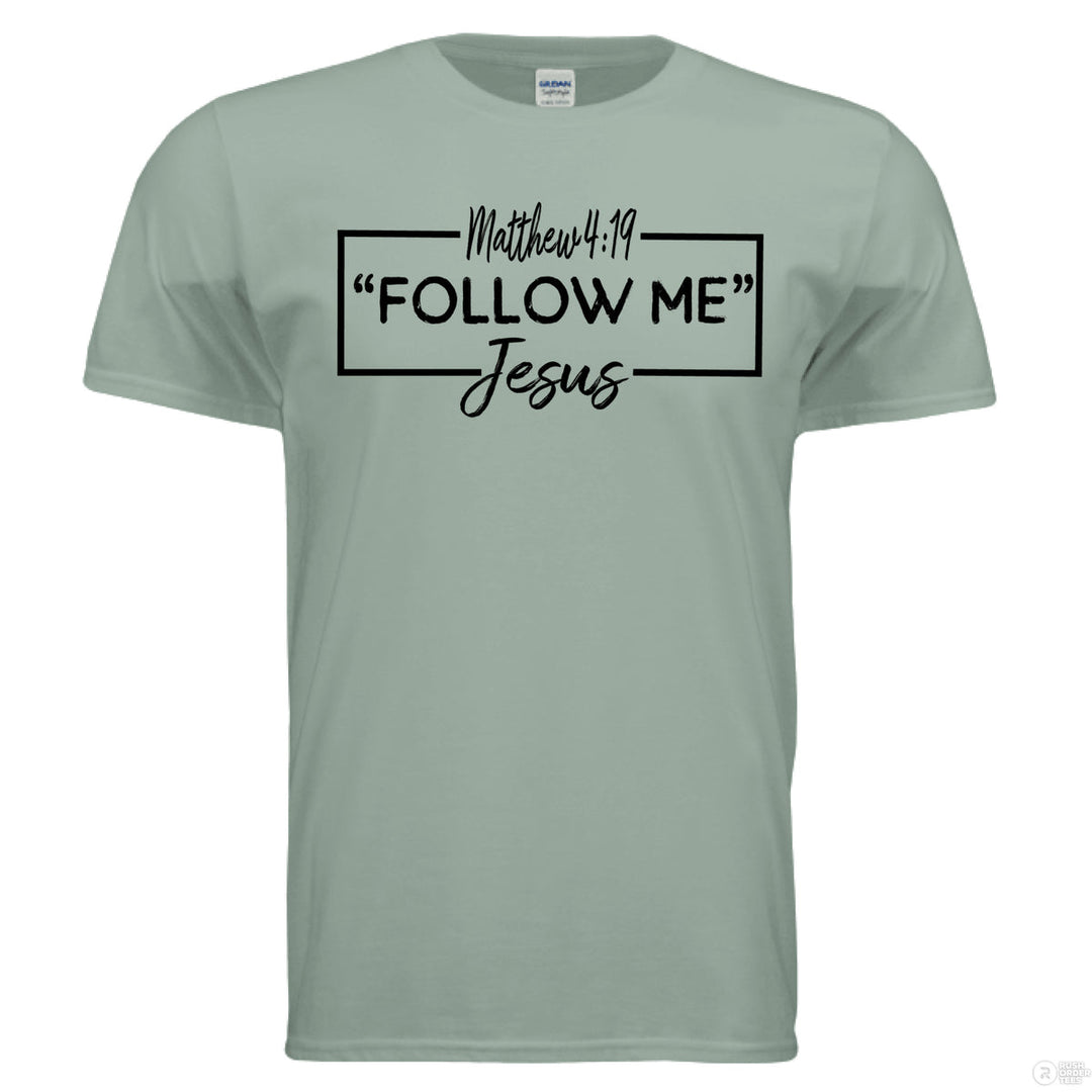 Sage Christian t-shirt with black Matthew 4:19 text reading “Follow Me – Jesus” in a modern boxed script and handwritten font style