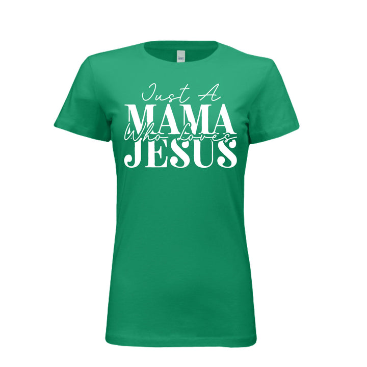 Women's kelly green t-shirt with white text reading "Just A Mama Who Loves Jesus" in bold and script fonts—a bold statement of faith and motherhood.